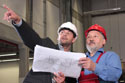 Men discussing blueprints